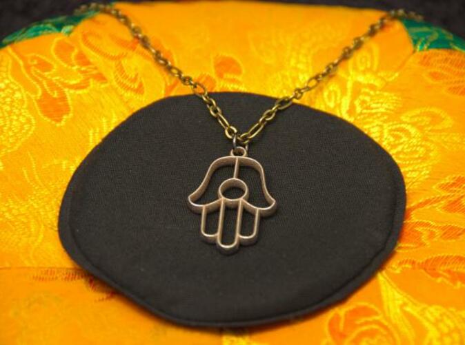 Photo of Stainless Steel pendant on a chain.