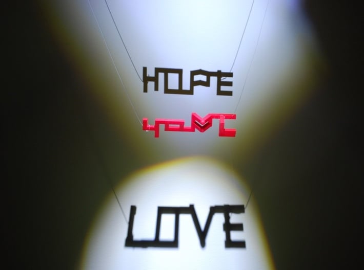 Hope and Love 3d printed Add light from 2 different angles and Hope and Love appear in the shadows!
