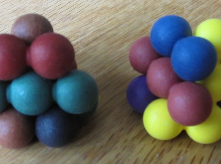 Ell of a puzzle (spheres) 3d printed Assembly into two interlocking "blossoms".