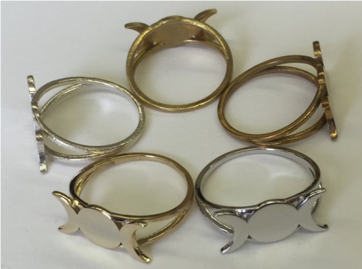Triple Moon Ring (customize) 3d printed A ring of rings. Starting clockwise at seven o'clock: 14k gold plated, raw silver, raw brass, raw bronze, rhodium plated.