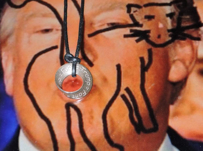Trump = Fart = Mobius  3d printed on a leather lanyard in front of an image on facebook :)