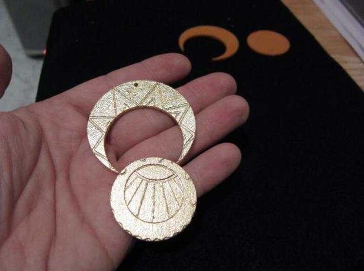 Estaban and Zia's Medallion from The Mysterious Ci 3d printed The finished gilded medallion in two parts