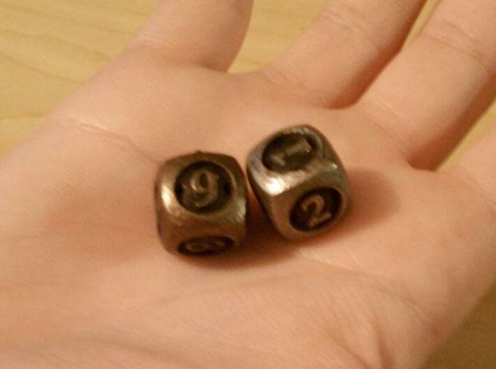 Overstuffed d6 3d printed In stainless steel and antique bronze glossy.