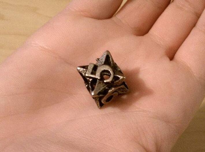 Pinwheel d6 3d printed In stainless steel and inked.