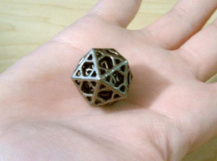 Cage d20 3d printed In stainless steel and inked.