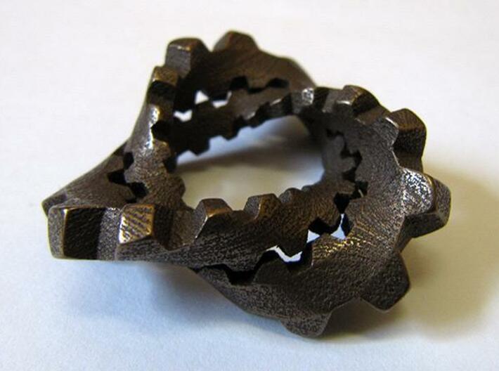 Trefoil with Cogs 3d printed Stainless steel with "antique bronze glossy" finish, from the side.