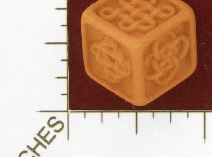 Celtic Die 3d printed Photo by Kevin Cook in an early, unpolished, orange strong and flexible.