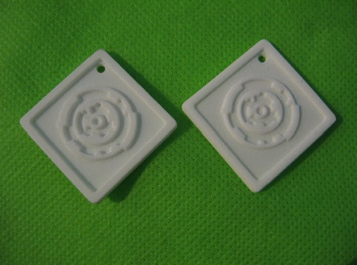 Revision Key Fob 3d printed Photos of actual prints in White Strong and Flexible and White Strong & Flexible Polished (right).