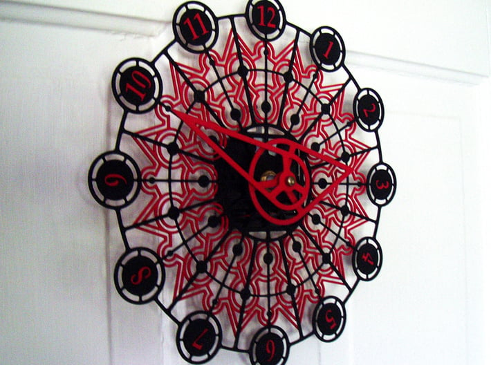 Kaleidoscope Clock - Part B 3d printed The completed Kaleidoscope Clock with Part A in Black Strong & Flexible and Part B in Red Strong & Flexible.This is a two-part clock face kit. This model is Part B. The first part is available at http://www.shapeways.com/model/580491
