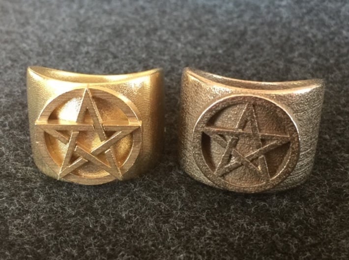Pentacle Ring - large (choose size) 3d printed So you can compare, here's the thick pentacle ring printed in raw brass next to the one printed in stainless steel. Can you see the differences in design? Don't worry if you can't; it's the sort of thing that only the designer might notice.  You can make 
