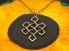 Endless Knot Pendant 3d printed Photo of Stainless Steel pendant on a chain.