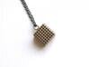 Perforated Cube Pendant  3d printed steel cube against white background