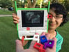OLPC XO-4 Optical Viewfinder for USB port 3d printed CuriousChild holding the OLPC XO-4 laptop with optical viewfinder.