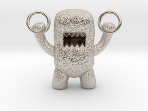 Domo Monster doing exercises with rings in Rhodium Plated Brass
