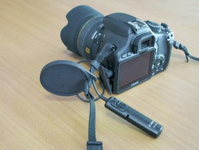 Holder for the camera lens cap . in Black Natural Versatile Plastic