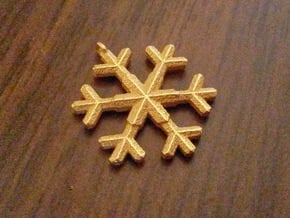 A wee snowflake pendant in Polished Gold Steel