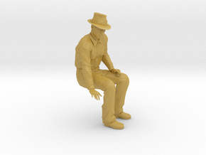 NG Fred sitting on bench wearing hat in Tan Fine Detail Plastic