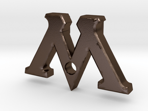 Badge "M" (Film Wizardry) in Polished Bronze Steel
