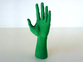 Human Hand in Green Processed Versatile Plastic