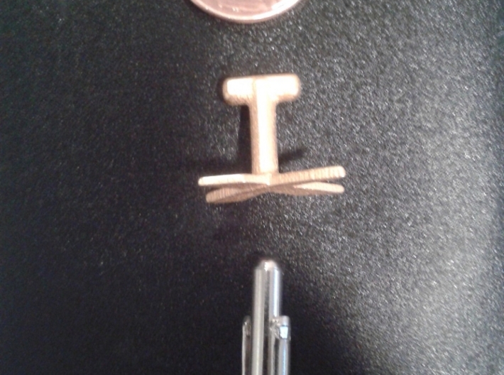 SpaceX Cufflink 3d printed Top down view, next to a penny and store bought cufflink for scale.