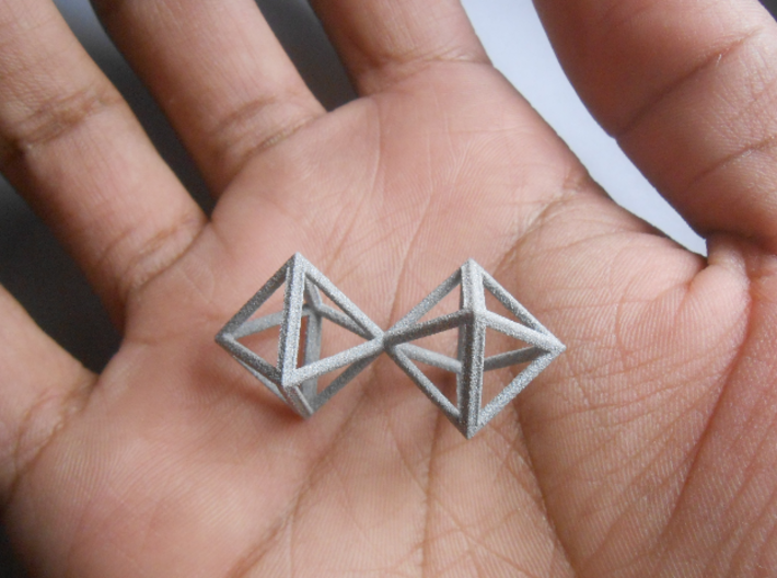 Faceted Twin Octahedron Frame Pendant Small 3d printed Twin Octahedron, held in palm of hand.