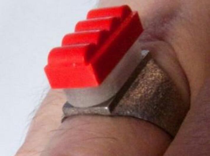 Two Stud Ring / Anillo Placa 2 3d printed Stainless Steel on the right hand. A Placa Chimenea (Transparent Detail) and a real red brick of TENTE attached to the ring (not included when ordering).