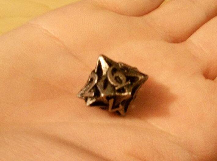 Pinwheel d10 3d printed In stainless steel and inked.