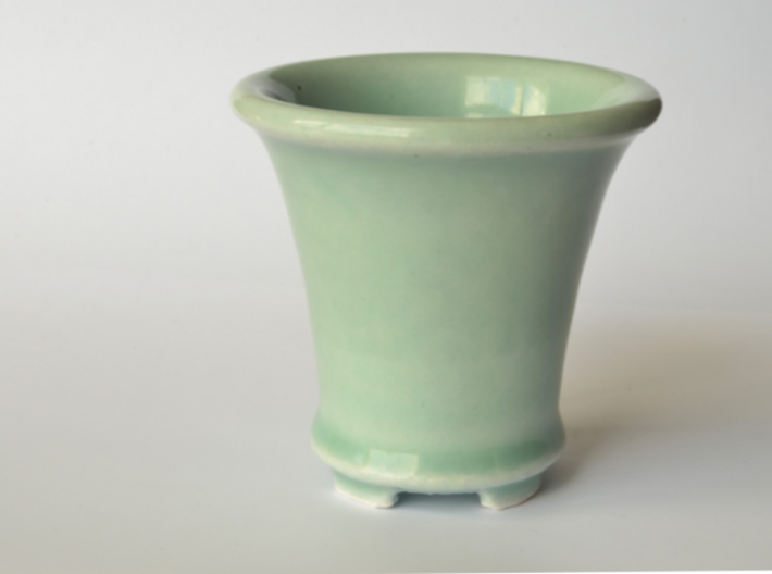 Round Bonsai-Style Shot Glass 3d printed Shown in Celedon Green glaze. This color appears to vary between a light blue and a light olive depending on the lighting.