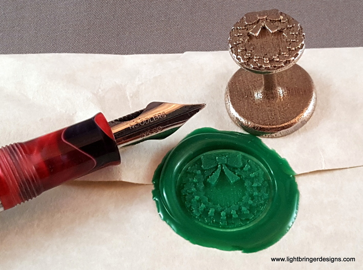 Holly Wreath Wax Seal 3d printed Holly Wreath wax seal with impression and fountain pen for scale.
