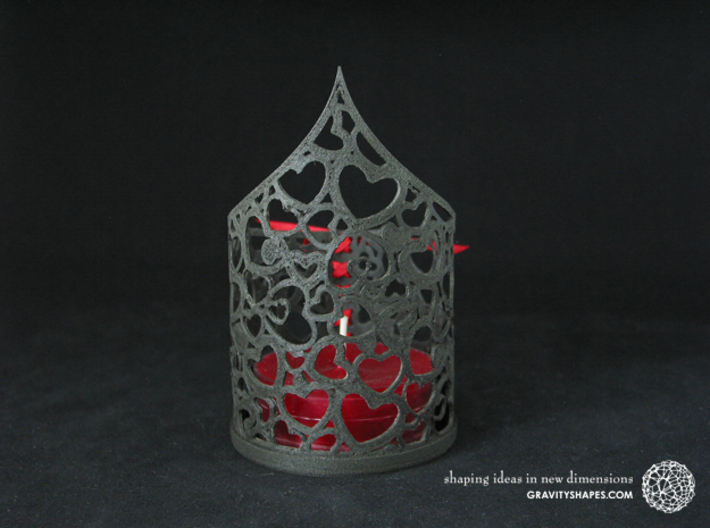 Pointed tealight holder with hearts 3d printed The photo shows its own print (FDM print) made of black wood with decorative lacing.