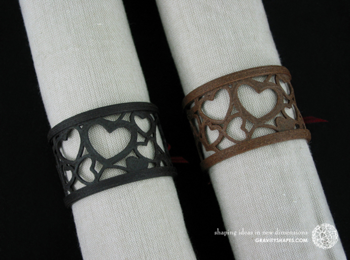  A large napkin ring with Hearts  3d printed The photo shows an own print (FDM print) made of brown and black wood incl. decorative lacing.