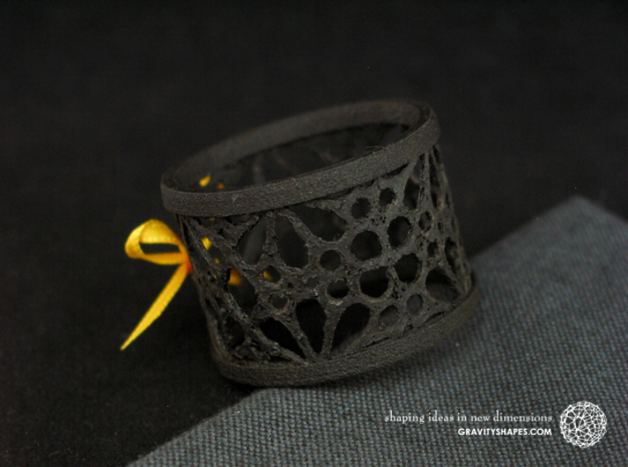 A small napkin ring with Mosaic-3a 3d printed The photo shows an own print (FDM print) made of black wood incl. decorative lacing.