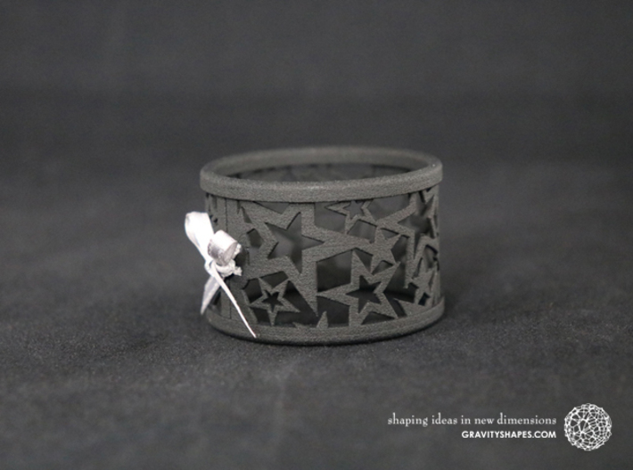 A large Christmas napkin ring with Stars 3d printed The photo shows a print made of black strong and flexible incl. silver lacing.