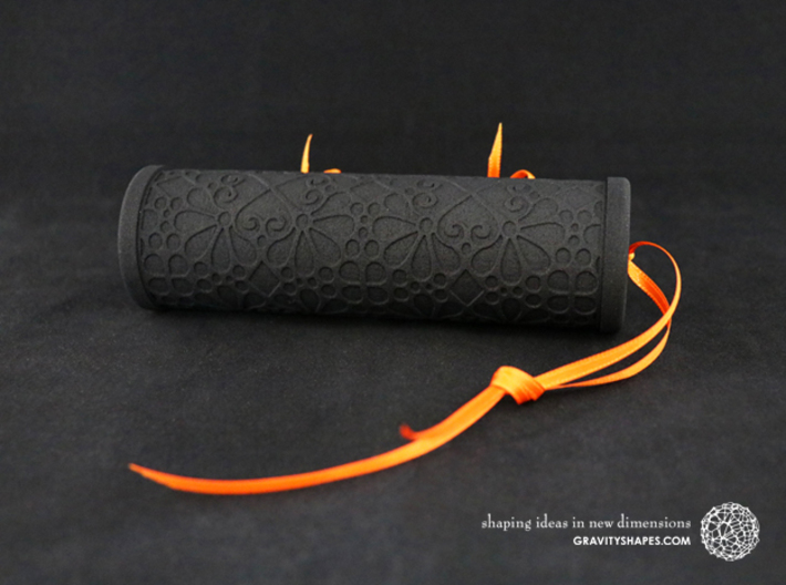Solid Gift roll XXL-size with Mosaic-3 (14 cm) 3d printed The photo shows a print made of black strong and flexible incl. orange lacing.