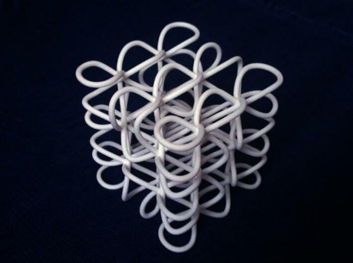 Celtic Knot Cube 3d printed The physical printed knot against a blue background.