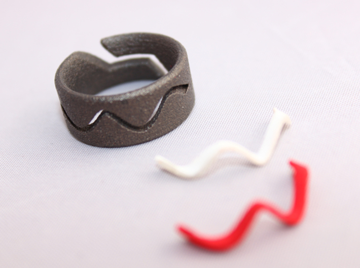 RING WAVE CUSTOMIZABLE Size 7 3d printed Ring wave with white or red plastic inserts.