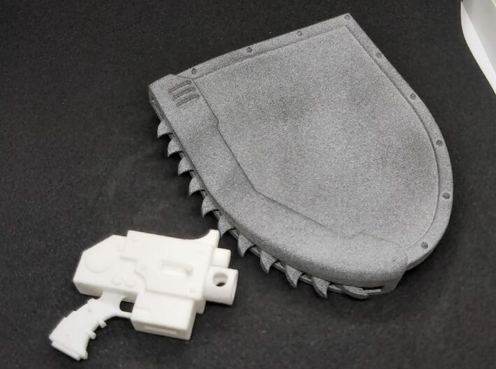 Action Figure Chainshield - Left Handed 3d printed Printed in Grey PA12, compared to Action Figure Bolt Pistol