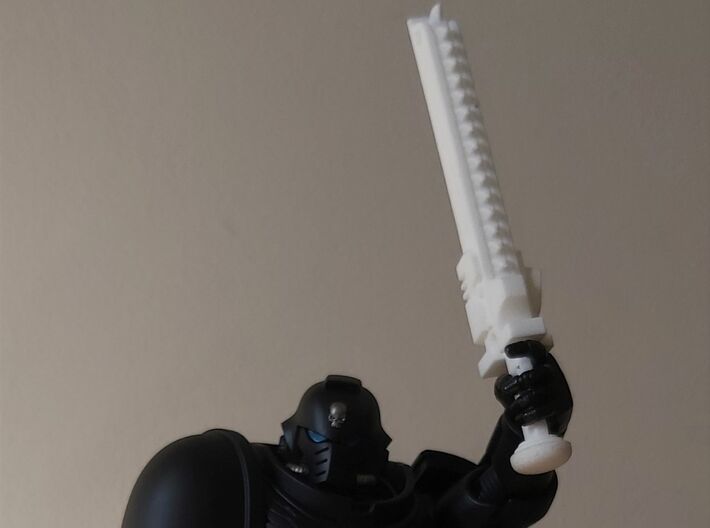 Action Figure Chainsword - Left Handed 3d printed Printed in White Natural Versatile Plastic, held by the hand of a 1:12 scale action figure