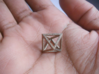 Faceted Minimal Octahedron Frame Pendant Small 3d printed Octahedron, held in palm of hand.