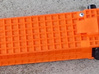 Surveying external battery LiPo Case 3d printed Dyed orange with Geodimeter plates in