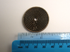 Labyrinth coin 3d printed shown with metric and imperial scales. Coin is 35 mm,  approx 1 and 6/16th inches across